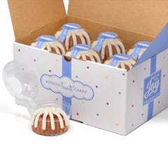 A box filled with 12 individually packaged Carrot bundtlets. 