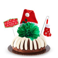 Bundt Cake with a green bow and Santa hat in the center, Christmas stocking deco, and Santa's Slice of Joy Card