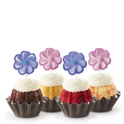 Bundtinis® topped with frosting and decorated with purple and pink flowers.