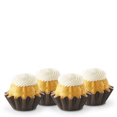Lemon flavored mini bundt cakes topped with a cream cheese frosting swirl.