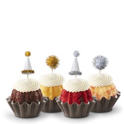 Bundtinis&reg; topped with frosting and decorated with gold and silver hats and pom poms.