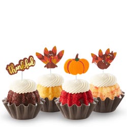 Thankful Turkey Bundtinis&reg; topped with frosting and decorated with pumpkin and turkey toppers as well as a topper with Thankful written in cursive. 
