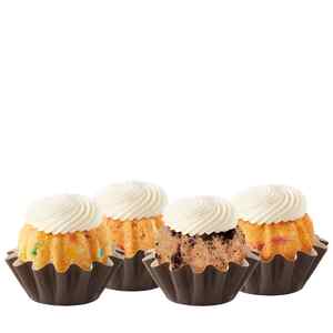 Four Bundtinis sitting in a row. Confetti, Strawberries & Cream, Oreo Cookies & Cream, and Lemon Raspberry.